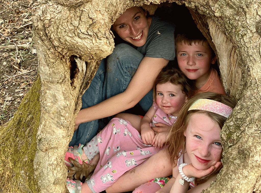 Author Brittney Tiller and her children shelter in a large tree. (Photo by Matt Tiller